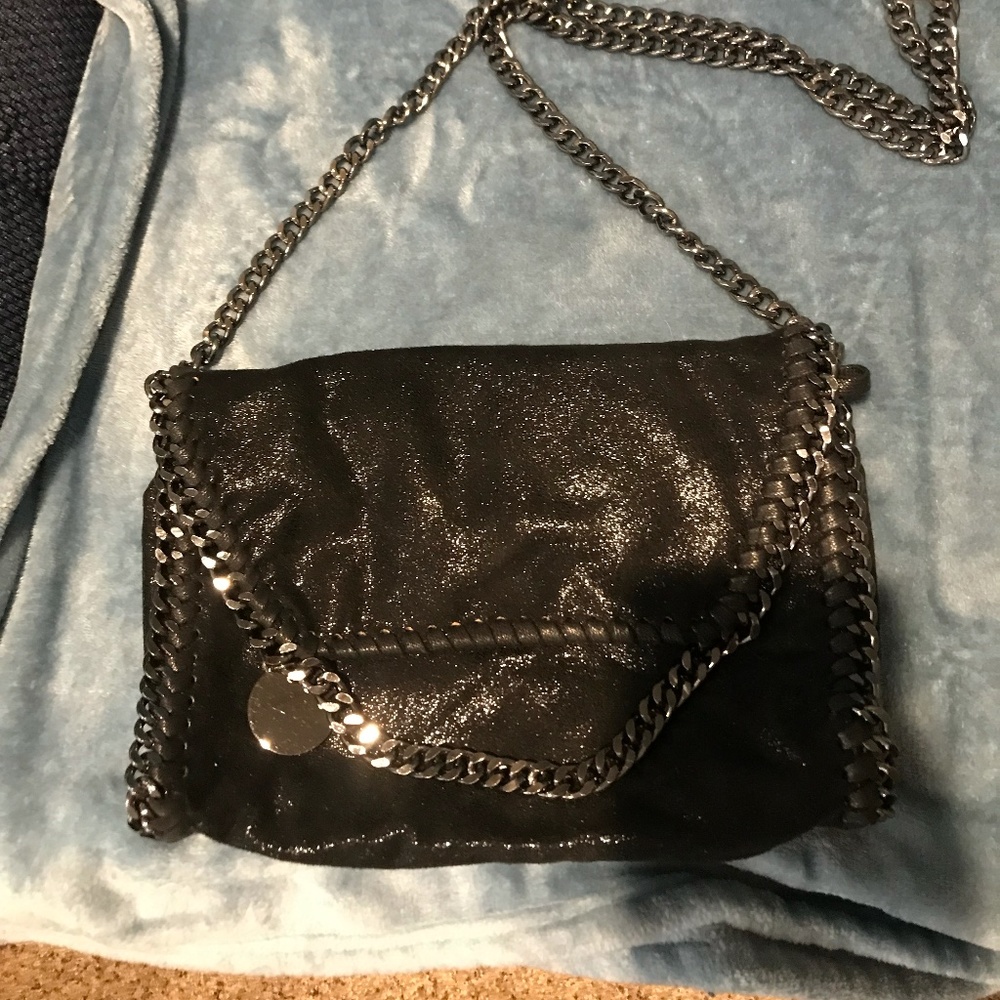 Elegant crossbody black color with a slight shimmer with light, Never used.
